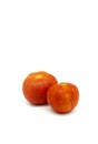 Two orange tomatoes on a white background Royalty Free Stock Photo