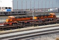 Two orange train engine cars coupled