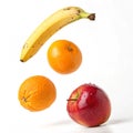 Two oranges, a banana, and an apple falling isolated on transparent background Royalty Free Stock Photo