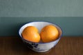 Two oranges fruit on a white ceramic bowl Royalty Free Stock Photo