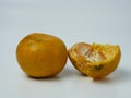 two oranges, one peeled on a white background Royalty Free Stock Photo