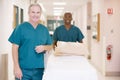 Two Orderlies Pushing Bed Down A Hospital Corridor Royalty Free Stock Photo