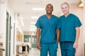 Two Orderlies Standing In A Hospital Corridor Royalty Free Stock Photo