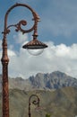 Two orante street lights, with a mountain range in the background