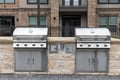 Two outdoor built in barbecue BBQ stainless steel grills at back yard of the residential complex Royalty Free Stock Photo