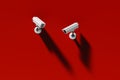 Two outdoor surveillance cameras on a red wall, security system Royalty Free Stock Photo