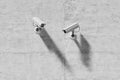 Two outdoor video surveillance cameras on a concrete wall Royalty Free Stock Photo