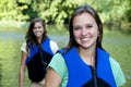 Two outdoorsy females with life jackets Royalty Free Stock Photo