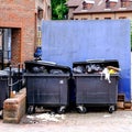 Two Overfilled Black Wheely Bins Royalty Free Stock Photo