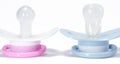 Two pacifiers on a white background Royalty Free Stock Photo