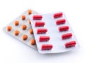 Two packages of red and orange tablets on a white background Royalty Free Stock Photo