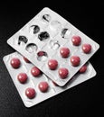 Two packets of pills on a black background Royalty Free Stock Photo
