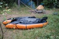 Two packrafts lie to dry in the camp, against the backdrop of a tent, in the forest, in summer. Active lifestyle concept Royalty Free Stock Photo