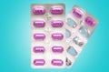 Two packs of purple pills that fulfill dreams, desires and wishes. Blue background. The concept of choice, insight and