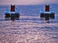 Two paddle boats without people floating on the sea water table in evening light Royalty Free Stock Photo