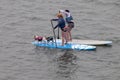 Two Paddle Surfers with two Dogs on surfboards at Morro Bay