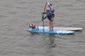 Two Paddle Surfers with two Dogs on surfboards on the waters of Morro Bay