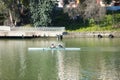 Two paddlers in a double canoe training on the river guadalquivir, seville. The paddlers prepare for the olympic games