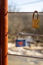 Two Padlocks Hooked on a Bridge