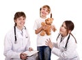 Two paediatrician treat happy child. Royalty Free Stock Photo