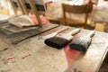 Paint brushes and painters knife lying ready for use on an artist table in an atelier