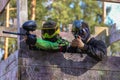 Two paintball shooters defending wooden tower Royalty Free Stock Photo