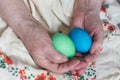 Two painted Easter eggs in the hands of an elderly lady Royalty Free Stock Photo