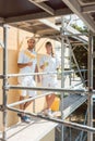 Two painters on scaffold looking into the camera Royalty Free Stock Photo