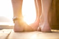 Two pair of feet from caucasian man and woman in love enjoying the sunset at the beach during summer holiday vacation. closer and Royalty Free Stock Photo