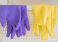Two pair of rubber gloves hanging on a white basket for housekeeping cleaning equipments Royalty Free Stock Photo