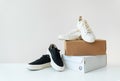 Two pairs of comfortable shoes in black and white stand on the table. Two boxes with new comfortable shoes for an active lifestyle Royalty Free Stock Photo