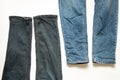 Two pairs of different men's jeans lie on a white background close-up Royalty Free Stock Photo