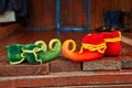 Two pairs of dwarf felt shoes at the entrance of an old wooden house. Dwarves came to visit Royalty Free Stock Photo