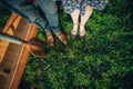 Two pairs of feet on green grass