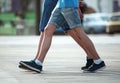 Two pairs of feet walking together men. friendships of friends Royalty Free Stock Photo