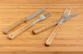 Two pairs of forks and knives with wooden handles Royalty Free Stock Photo