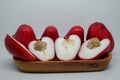 two pairs of fresh cut Malay apple served on wooden tray Royalty Free Stock Photo