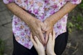 Two pairs of hands of people of different ages, wrinkled hands of an elderly woman and young hands of a teenager, concept of age,