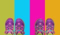 Two pairs of kid shoes on four pastel colors background