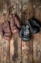 two pairs of leather vintage boxing gloves hanging on a nail Royalty Free Stock Photo
