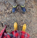 Two pairs legs in colorful gumboots