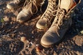 Two pairs of male and female beige boots with laces for outdoor activities on a sand background Royalty Free Stock Photo