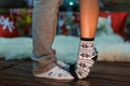 Two pairs of male and female legs in socks. Female feet stand on the toes on the male leg. Royalty Free Stock Photo