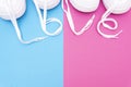 Two pairs of matching white sneakers with the lettering LOVE made of the laces on a contrast pink blue background Royalty Free Stock Photo