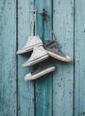 Two pairs of old worn textile sneakers hang on a nail Royalty Free Stock Photo