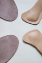 Two pairs orthopedic shoe insoles isolated on beige background Royalty Free Stock Photo