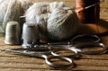 TWO PAIRS OF SCISSORS WITH GREY DARNING YARN A NEEDLE, OLD WOODEN SPOOL WITH BROWN THREAD AND METAL THIMBLES