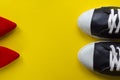 Two pairs of shoes opposite on yellow background