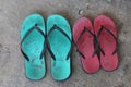 Two pairs of slippers on the cement floor. Two house slippers for men and women Royalty Free Stock Photo