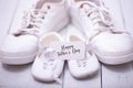 Two pairs of sports shoes on a white wooden background. The shoes of father and son or daughter. Fathers day concept Royalty Free Stock Photo